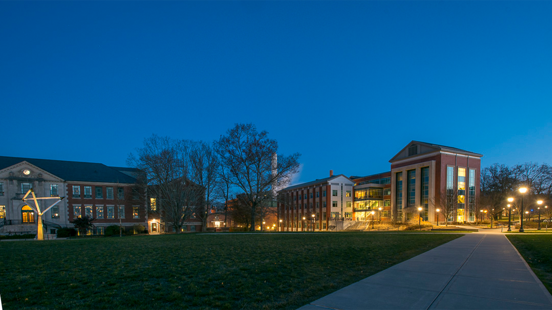 The Gentry Building lit up at night.